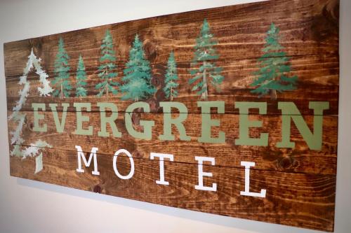 a sign that reads american motel hanging on a wall at Evergreen Motel in Libby