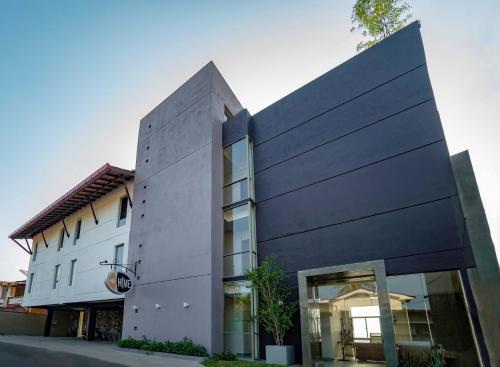 a black and white building on a street at Hive 68 - Hotel and Resorts (Negombo) in Negombo
