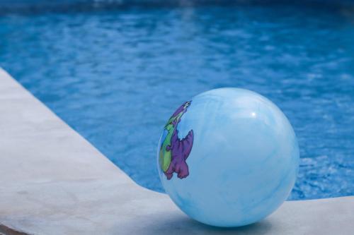 a white ball sitting next to a swimming pool at The Hillside Pranburi Resort in Pran Buri