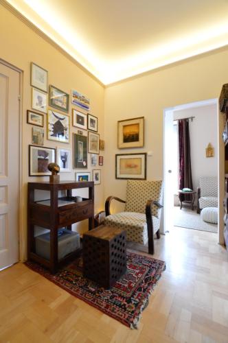 a living room with a fireplace and pictures on the wall at Art Styles Boutique Apartment Szentendre in Szentendre