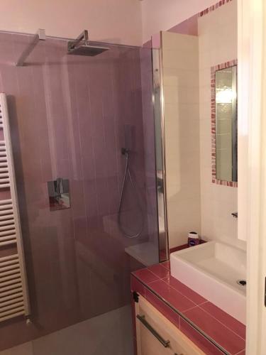 a bathroom with a shower with a red counter top at CASA MADDALENA in Lierna