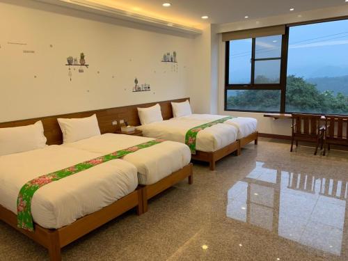 Una cama o camas en una habitación de 巨缿民宿巨象民宿