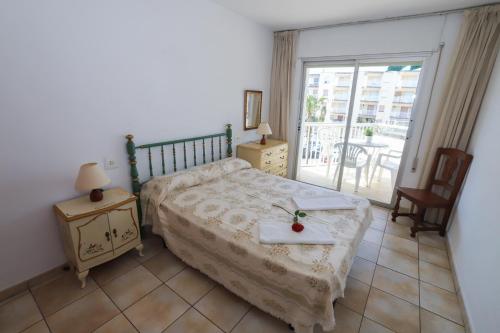 a bedroom with a bed with a tray on it at COSTA DAURADA APARTAMENTS - Regueral in Cambrils
