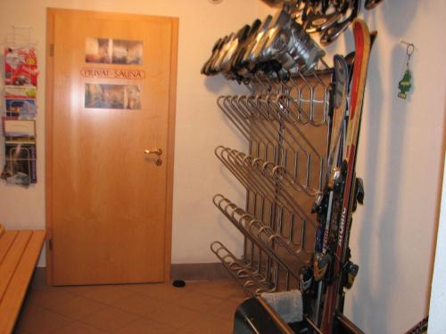 a room with a bunch of skis hanging on a wall at Appartementhaus Brunnenhof in Wagrain