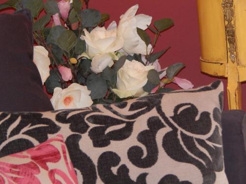 a bouquet of white roses sitting next to a pillow at Athens-Plaka, Peter’s beautiful apartment in Temple of Zeus in Athens