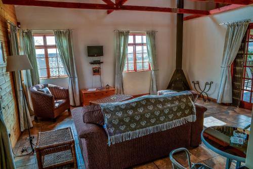 a living room with a couch and a table at Stone Hill in Magaliesburg
