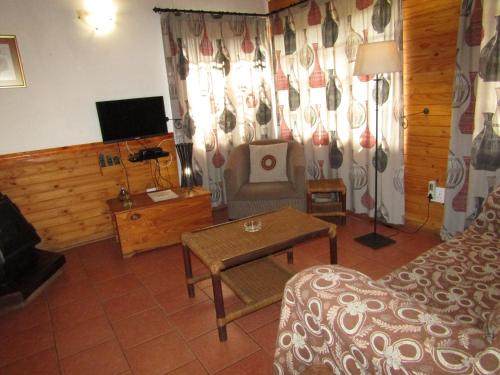 a living room with a couch and a table at Stone Hill in Magaliesburg