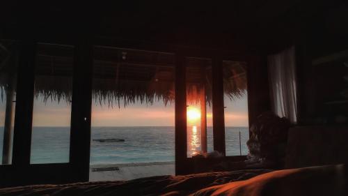 a view of the ocean from a bedroom window at Kimo Resort Pulau Banyak Aceh Singkil in Alaban