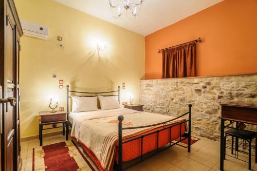 a bedroom with a bed and a table and a piano at Mouzaliko Guesthouse Mansion in Kambos