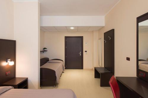 Postel nebo postele na pokoji v ubytování Grand Hotel Adriatico