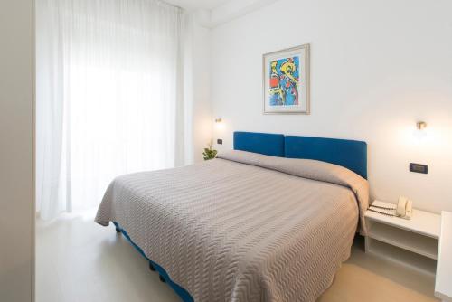 Postel nebo postele na pokoji v ubytování Grand Hotel Adriatico