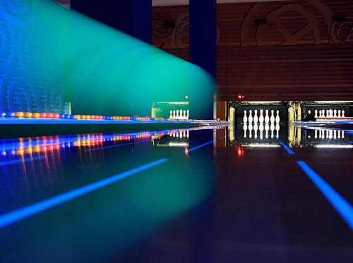 a bowling alley with blue and green lanes at Riga Islande Hotel with FREE Parking in Rīga