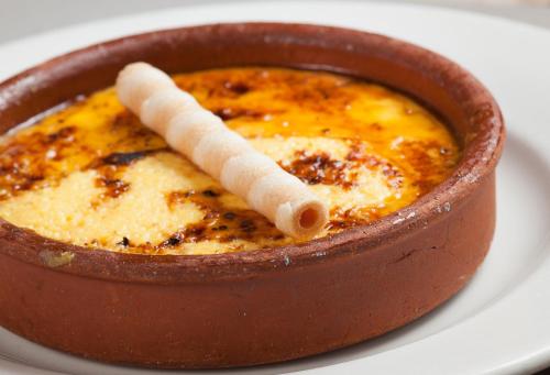 a bowl of food on a white plate at Hotel Restaurant Les Brases in Sort
