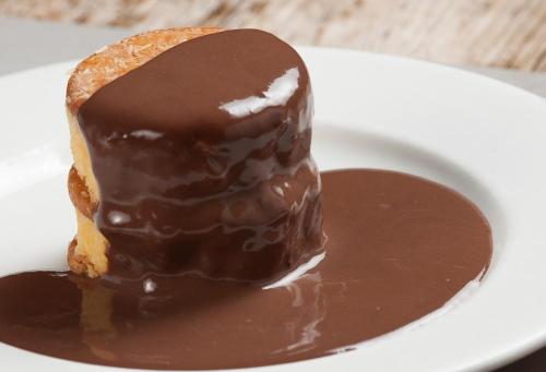 a piece of chocolate cake on a white plate at Hotel Restaurant Les Brases in Sort