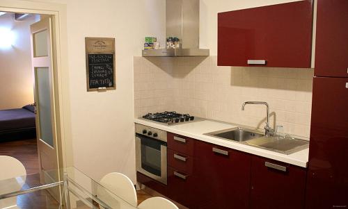 a kitchen with a sink and a stove top oven at Casa Vacanza Pablo Castello in Cagliari