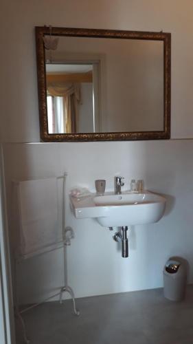 a bathroom with a white sink and a mirror at Florian in La Spezia