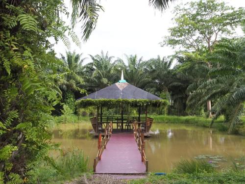 a gazebo in the middle of a pond at Pru Valley Thaley Tai Resort in Ban Don Phlap (1)