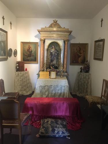 a room with a altar with a painting on the wall at ALBERGUE CASA BAZTAN in Uterga