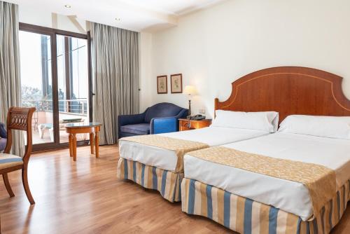 Llit o llits en una habitació de Hotel Termes Montbrió