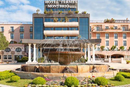 a fountain in front of a hotel in front of a building at Termes Montbrio Hotel & Spa in Montbrió del Camp