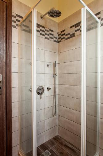 a shower with a glass door in a bathroom at Fοivos and Athina Villas in Archanes