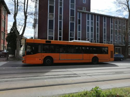 an orange bus parked on the side of a street at Hotel Mondial in Marghera