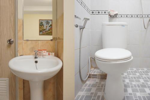 a bathroom with a toilet and a sink at Sabana Homestay in Yogyakarta
