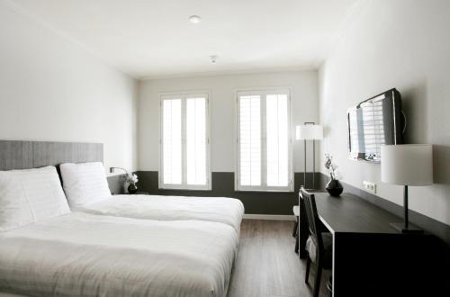 Een bed of bedden in een kamer bij Fletcher Hotel - Restaurant Nautisch Kwartier