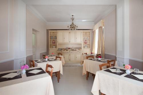 a dining room with two tables and a kitchen at Villa Cristina in Castellina in Chianti