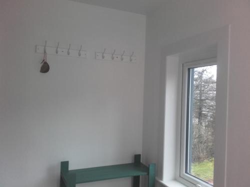 a room with a window and a green shelf at Old Harbour Master's self-catering apartment in Fort William