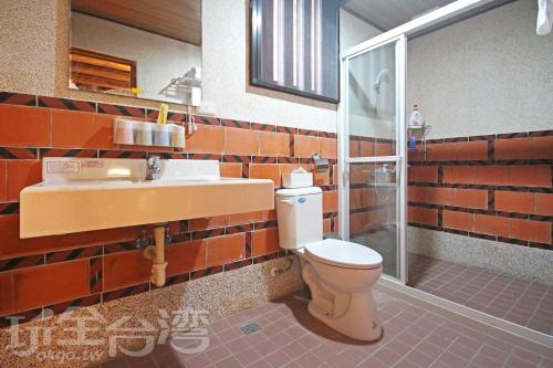 a bathroom with a toilet and a sink at Water 97 in Jincheng