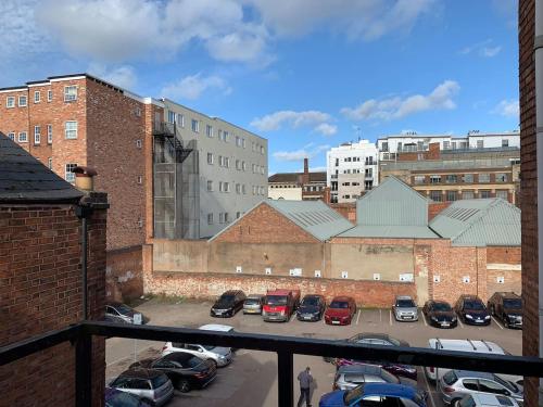 a parking lot with parked cars in a city at GRANBY APARTMENTS F-2 in Leicester