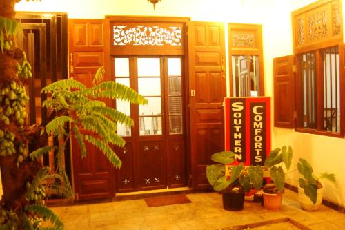 a lobby with a large door with plants in front of it at Southern Comforts - Galle Fort in Galle