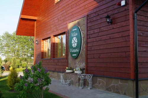 a building with a sign on the side of it at Vila Viesai in Trakai