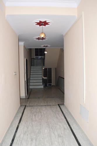 an empty hallway with a ceiling fan and stairs at Laxmi Mahal in Udaipur