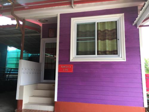 a purple house with a window and a door at บุญจินดา รีสอร์ท in Ban Phayom