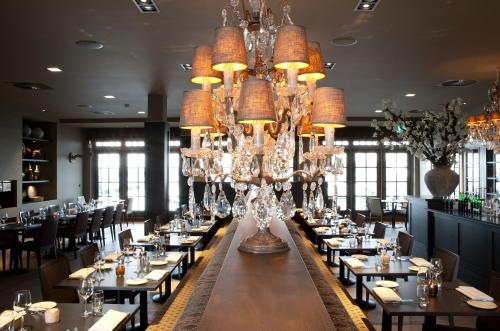 a large dining room with tables and chandeliers at Fletcher Hotel - Restaurant Nautisch Kwartier in Huizen