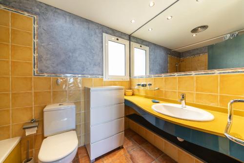 a bathroom with a toilet and a sink at Apartment Colette in L'Escala