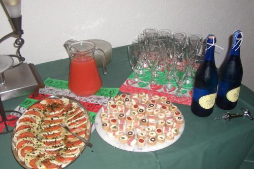 two pizzas on a table with bottles and glasses at Pension Burk in Bad Endbach