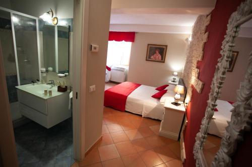 a bathroom with a bedroom with a bed and a sink at Le Due Sicilie in Tropea