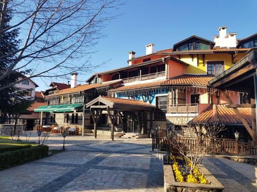 a large building with a courtyard in front of it at Hotel Tanne in Bansko