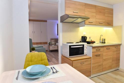a kitchen with a table with a blue plate on it at La Perla Apartments in Kalamata