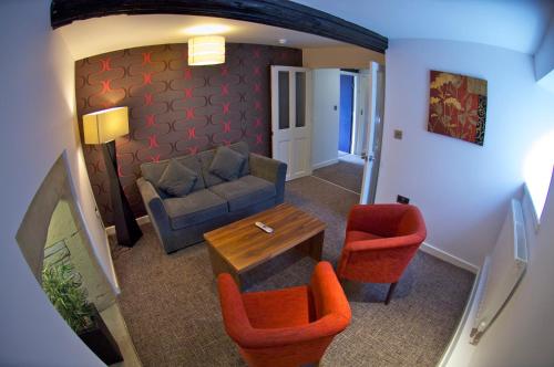 a living room with a couch and chairs and a table at Best Western Plus Lancashire Manor Hotel in Skelmersdale