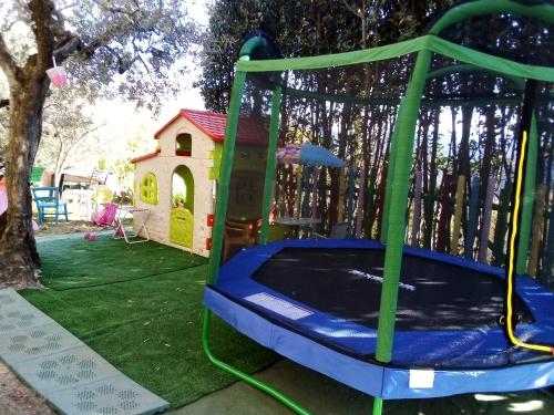 a trampoline in a yard with a play house at Guesthouse Runcini in Ferentillo