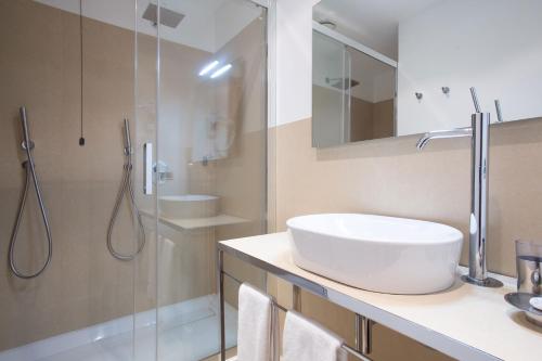 a bathroom with a white sink and a shower at Brianteo Hotel Residence and Restaurant in Burago di Molgora