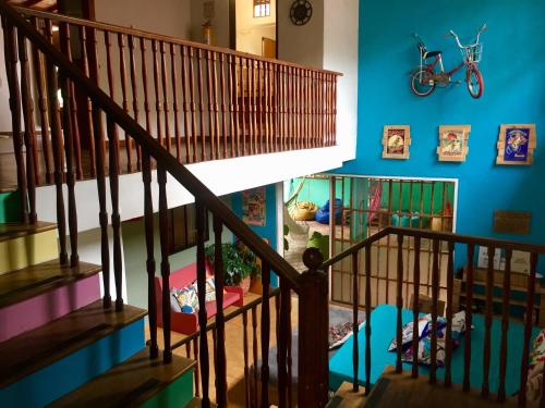 a staircase in a house with a bike on the wall at Yolo Hostel Medellin in Medellín