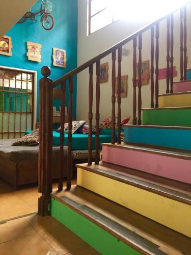 a stairway in a room with a bed and a stair case at Yolo Hostel Medellin in Medellín