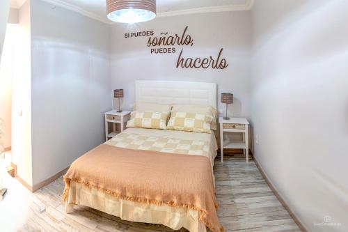 a bedroom with a bed and a sign on the wall at Sarelen in Santa Cruz de la Palma