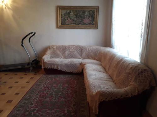 a living room with a white couch and a window at Guli in Gori