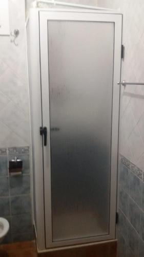 a glass shower door in a bathroom with a sink at Studio avec piscine à Mirador cabo négro in Cabo Negro